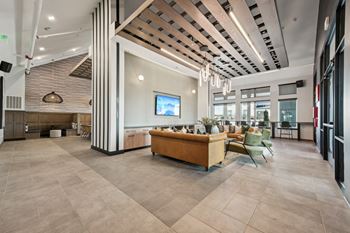 A modern living room with a flat screen TV and a sofa.